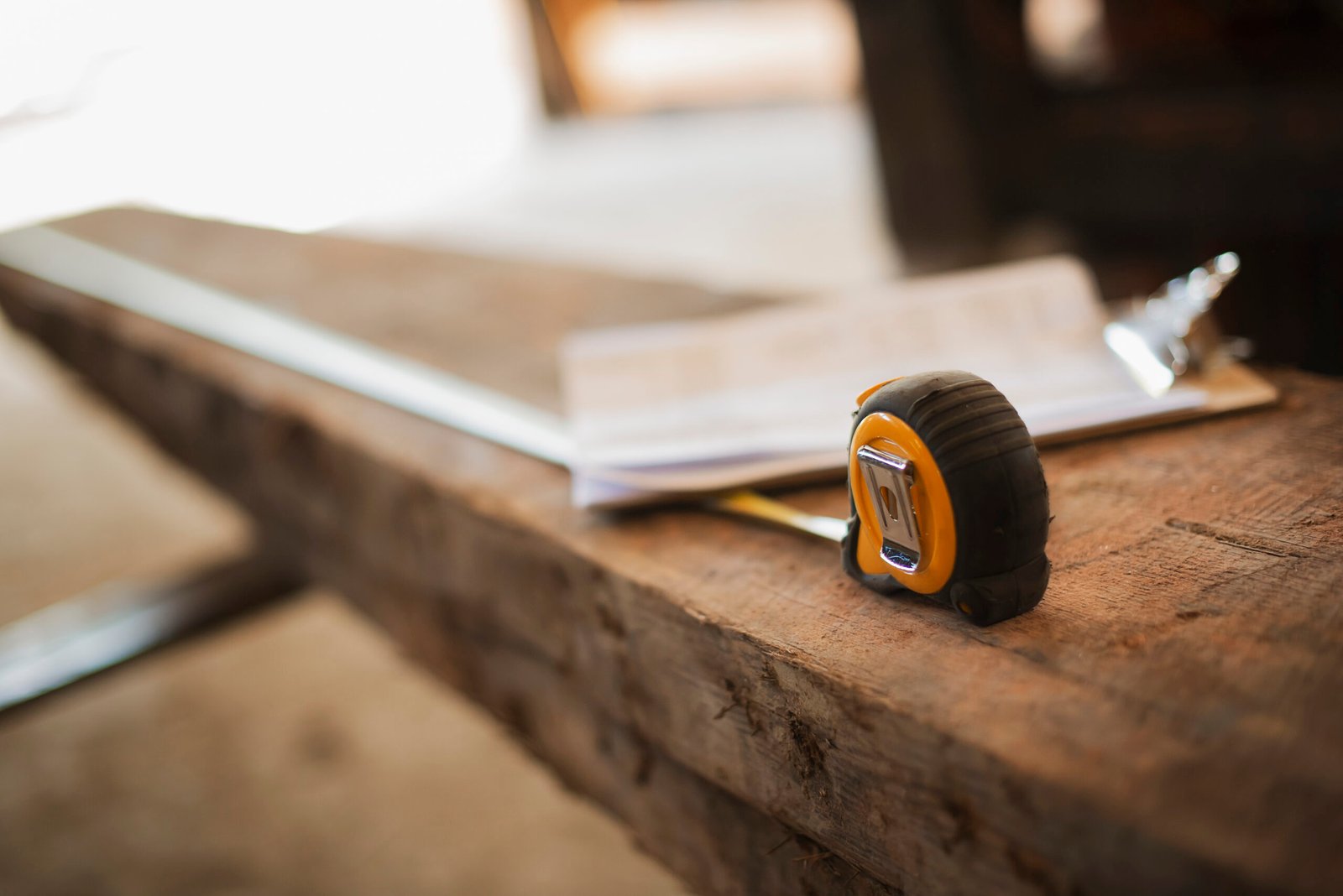 Reclaimed Lumber Yard,USA,A reclaimed timber yard. Recycled plank of wood, measuring tape and a clipboard with paperwork.